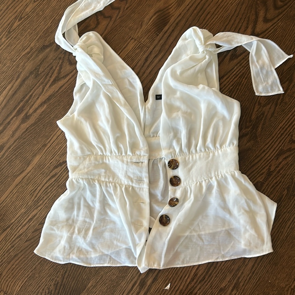 White top with brown buttons